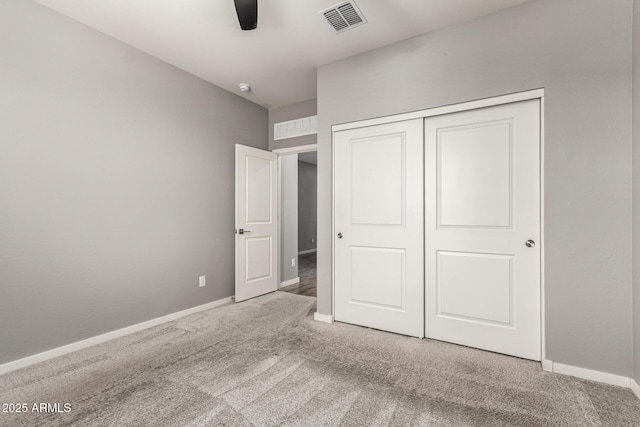 unfurnished bedroom featuring carpet floors, baseboards, a closet, and ceiling fan