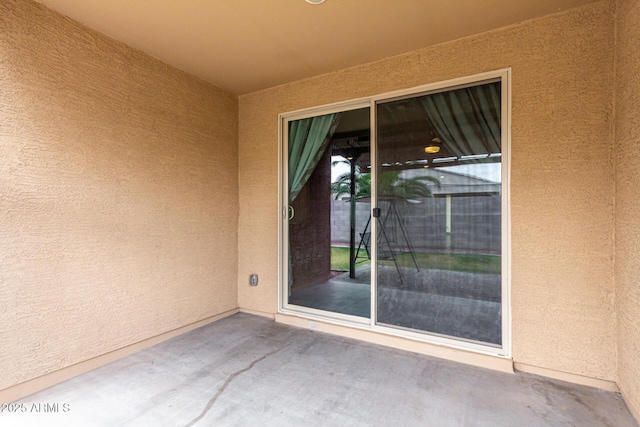 doorway to property with stucco siding and a patio