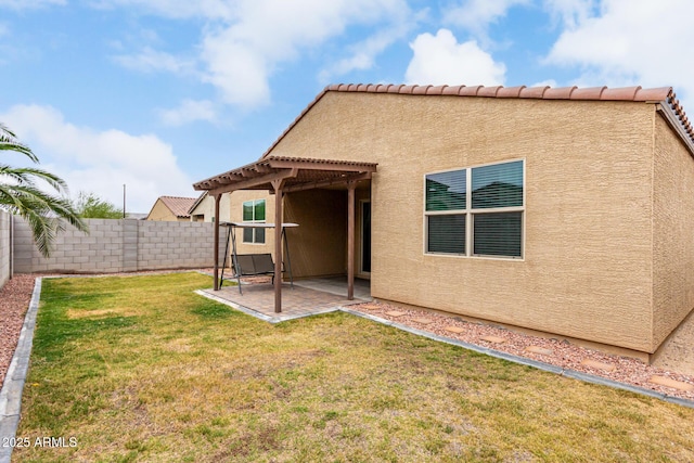 back of house featuring stucco siding, a patio area, and a pergola