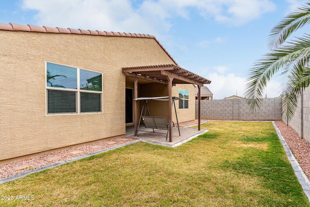 rear view of house featuring a pergola, a patio, and stucco siding