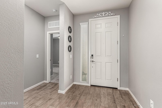 entrance foyer featuring wood finished floors and baseboards