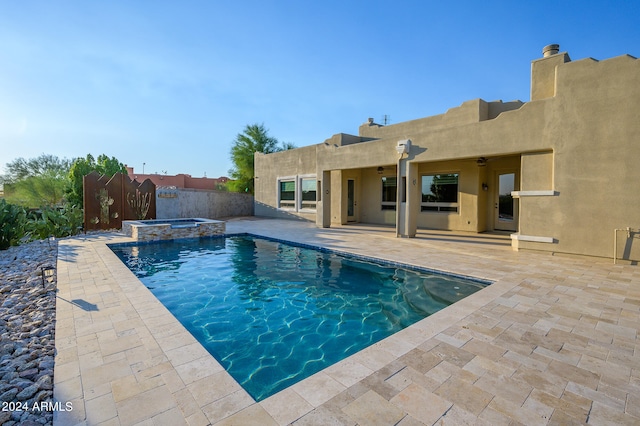 view of pool with an in ground hot tub and a patio area