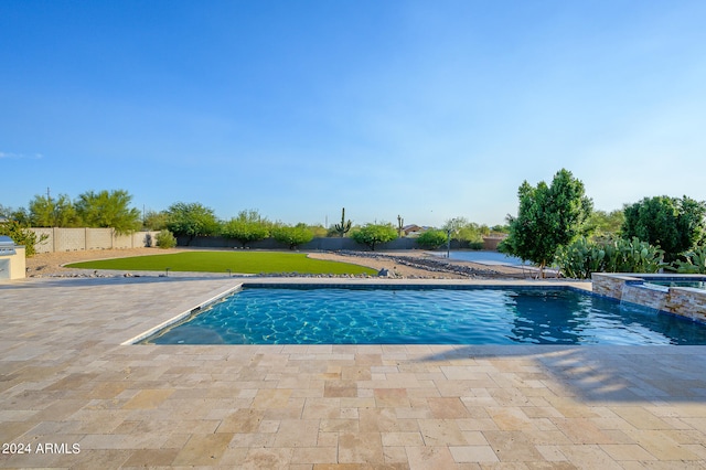 view of swimming pool with a lawn and a patio area