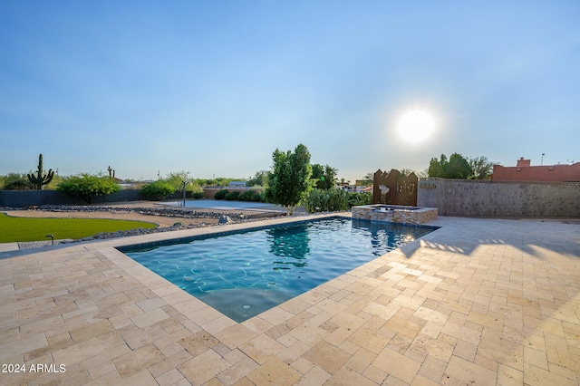 view of swimming pool featuring an in ground hot tub and a patio