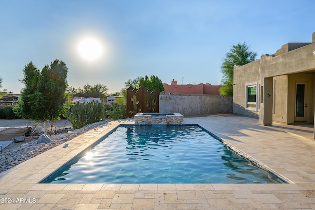 view of pool featuring a patio and an in ground hot tub