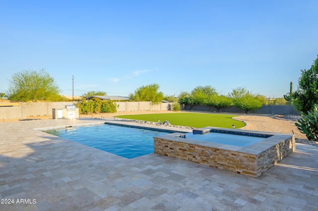 view of pool with a yard, a patio area, and an in ground hot tub