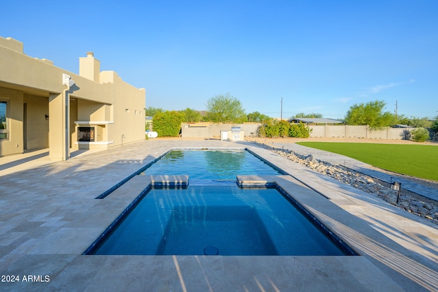 view of swimming pool featuring a yard and a patio