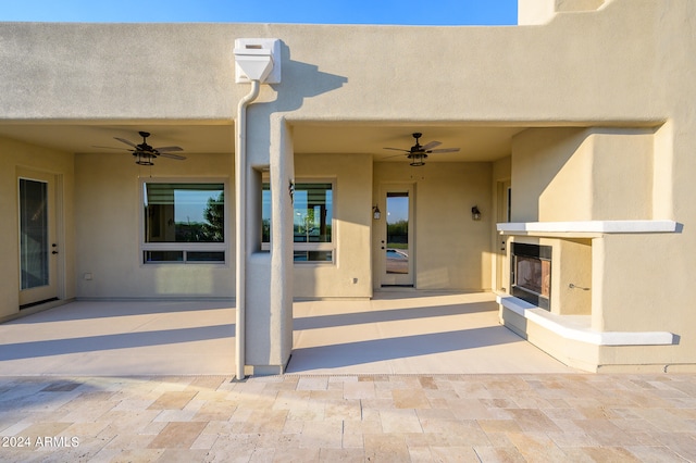 doorway to property featuring a patio and ceiling fan