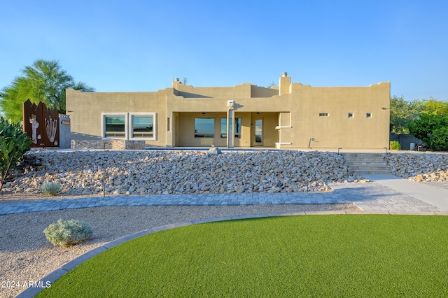 southwest-style home featuring a front yard