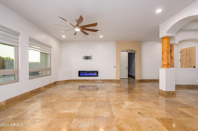 unfurnished living room with ceiling fan