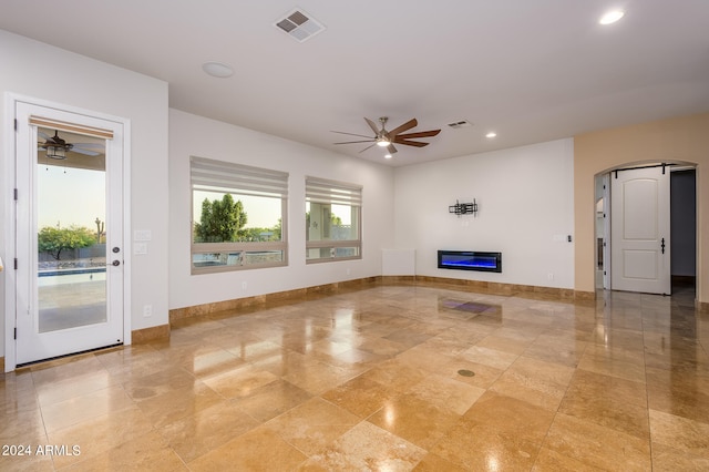 unfurnished living room featuring ceiling fan