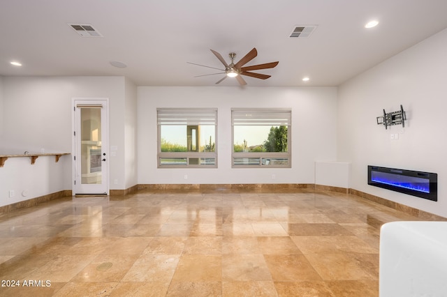 unfurnished living room featuring ceiling fan