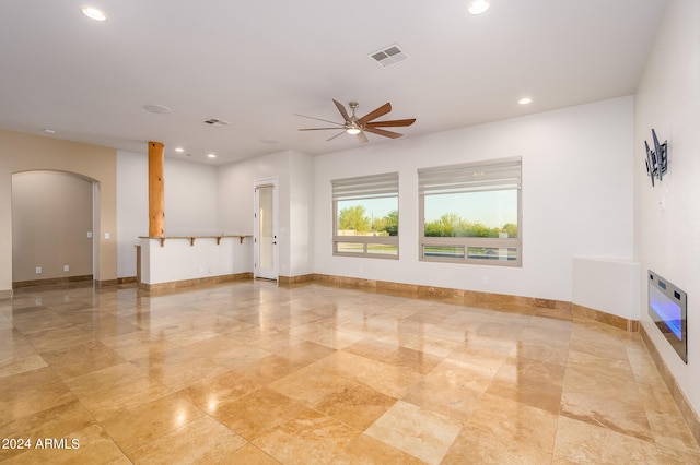 unfurnished living room with ceiling fan