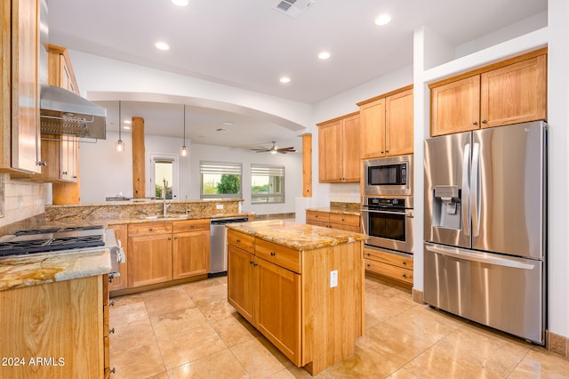 kitchen with ceiling fan, kitchen peninsula, decorative light fixtures, extractor fan, and appliances with stainless steel finishes