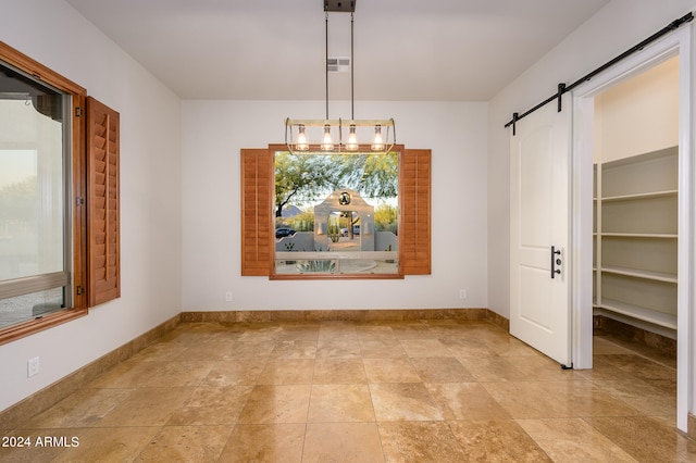 unfurnished dining area featuring a barn door