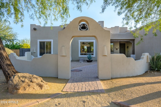 pueblo revival-style home featuring a patio area