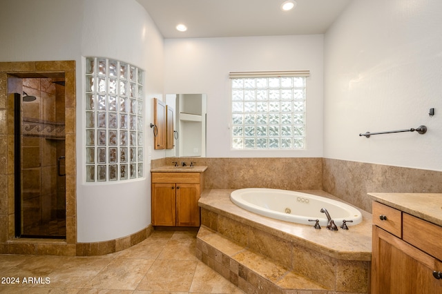 bathroom featuring vanity, separate shower and tub, and tile patterned floors