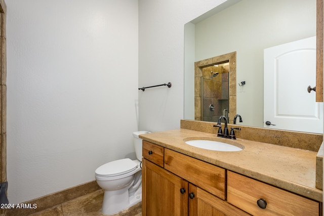 bathroom featuring tiled shower, vanity, toilet, and tile patterned floors