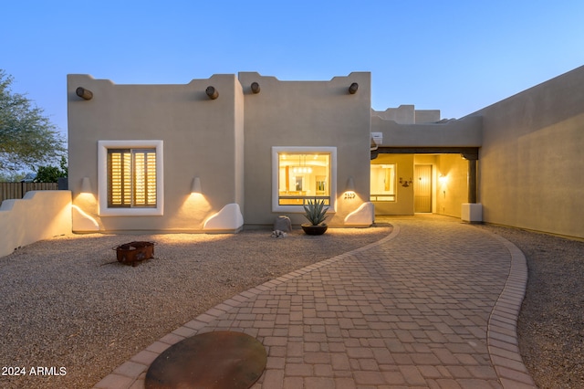 back house at dusk with a patio