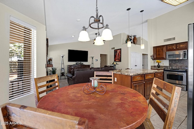 4131 E Cascalote Dr, Cave Creek, AZ 85331 - dining space featuring light tile patterned flooring, a chandelier, and lofted ceiling