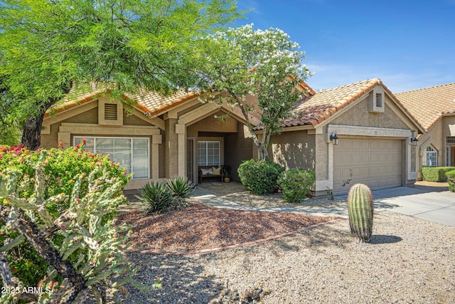 4131 E Cascalote Dr, Cave Creek, AZ 85331 - view of front of house featuring a tiled roof, stucco siding, a garage, and driveway