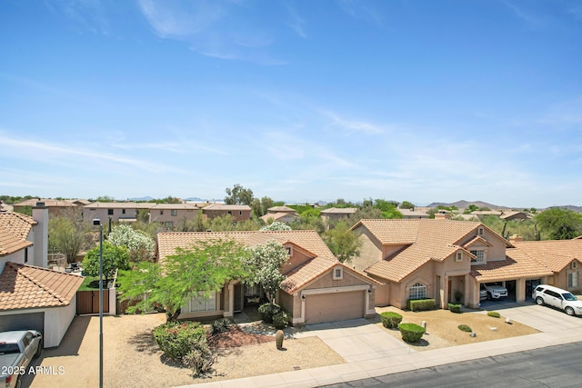4131 E Cascalote Dr, Cave Creek, AZ 85331 - view of front of house featuring a residential view, stucco siding, a tile roof, driveway, and a garage