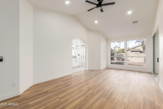 unfurnished living room featuring light hardwood / wood-style floors, ceiling fan, and lofted ceiling