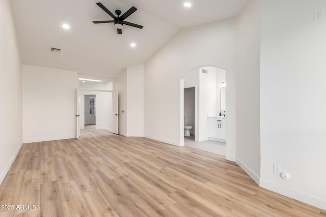 unfurnished room featuring ceiling fan, light wood-type flooring, and vaulted ceiling