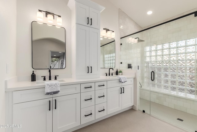 bathroom featuring vanity, vaulted ceiling, and walk in shower