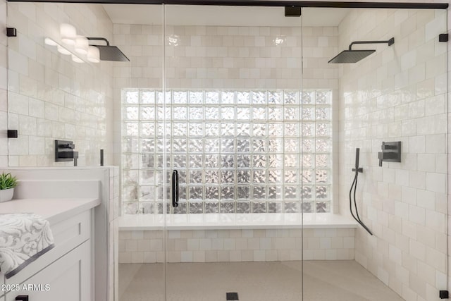 bathroom featuring tile patterned floors, vanity, and a shower with shower door