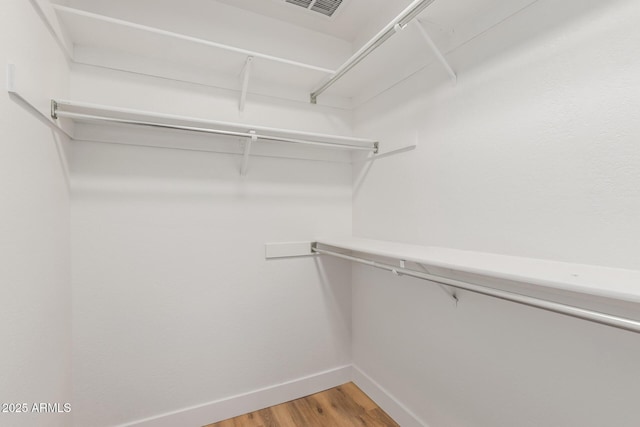 spacious closet featuring hardwood / wood-style floors