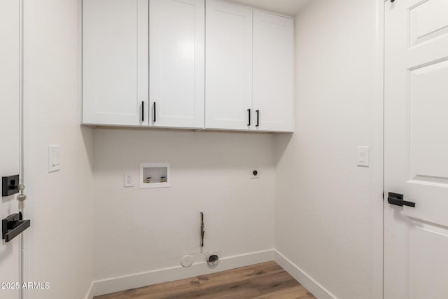 clothes washing area with cabinets, washer hookup, hookup for an electric dryer, hookup for a gas dryer, and light hardwood / wood-style flooring