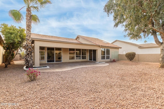 rear view of property featuring a patio area