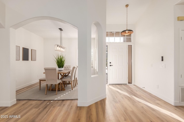 foyer with a high ceiling and hardwood / wood-style flooring