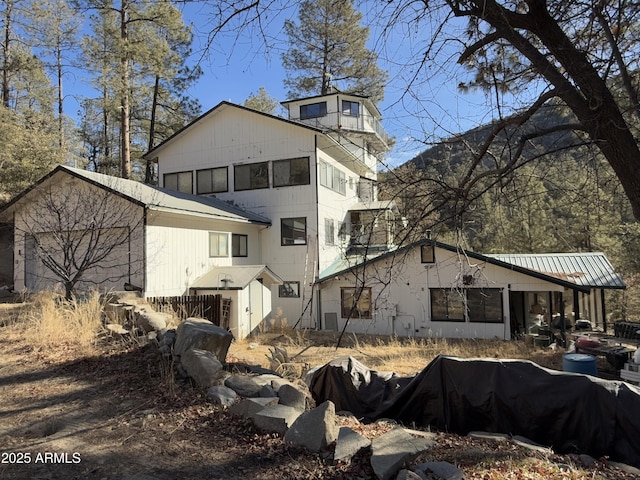 back of property featuring metal roof