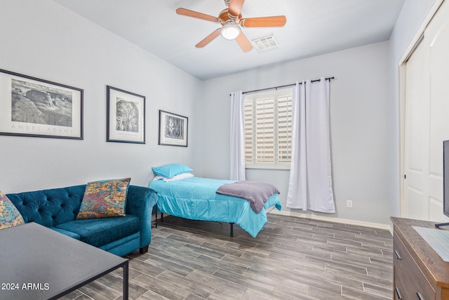 bedroom featuring ceiling fan, a closet, and hardwood / wood-style floors