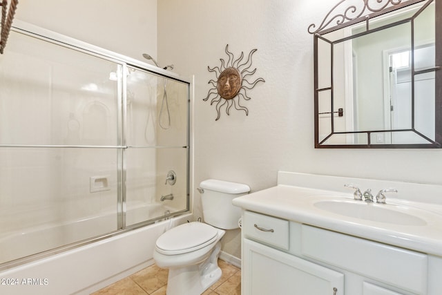 full bathroom featuring vanity, tile patterned flooring, toilet, and combined bath / shower with glass door