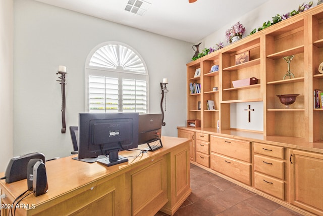 office space with dark tile patterned flooring