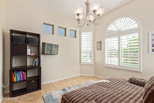 tiled bedroom featuring a chandelier