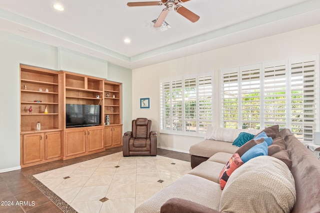 living room featuring light tile patterned floors and ceiling fan