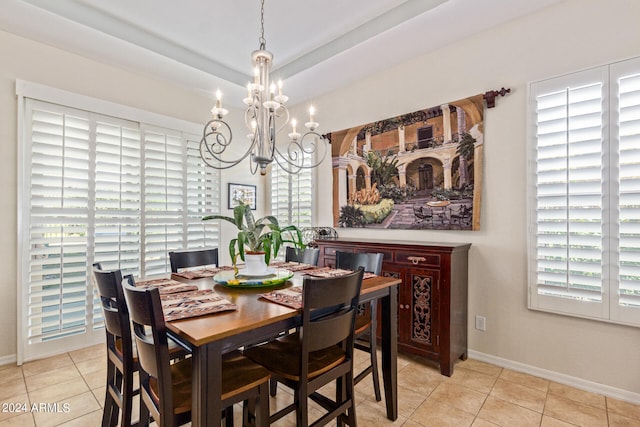 dining space with light tile patterned flooring, plenty of natural light, and a chandelier