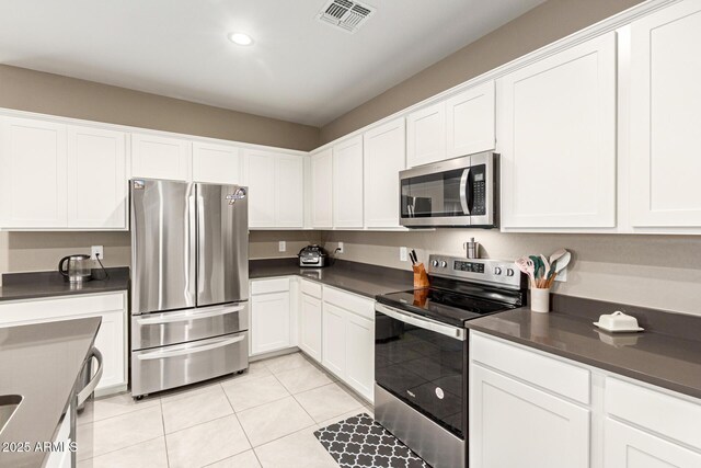 37008 N Hinterwald Way, San Tan Valley, AZ 85143 - kitchen featuring dark countertops, white cabinets, stainless steel appliances, and visible vents