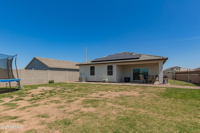 37008 N Hinterwald Way, San Tan Valley, AZ 85143 - rear view of house featuring solar panels, a trampoline, a lawn, a fenced backyard, and a patio