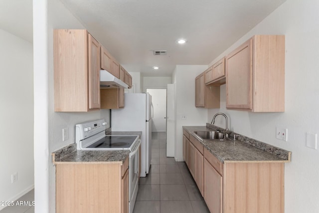 kitchen with white range with electric cooktop, dark countertops, light brown cabinetry, a sink, and under cabinet range hood