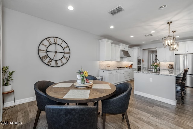 dining space featuring light hardwood / wood-style floors and sink