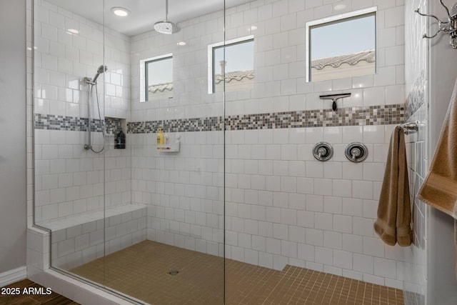 bathroom with a tile shower