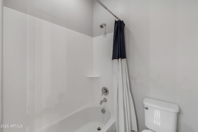 bathroom with shower / bath combo and toilet