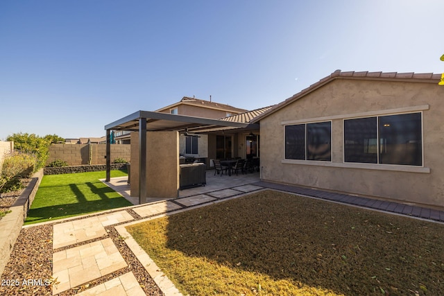 rear view of property with a yard and a patio area