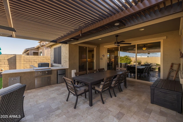 view of patio featuring a pergola, grilling area, ceiling fan, and an outdoor kitchen