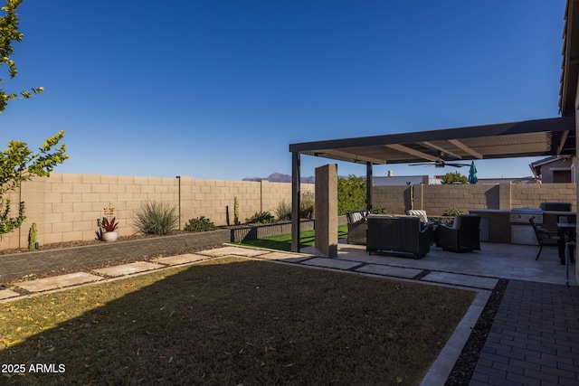 view of yard featuring a pergola, a patio area, an outdoor living space, and an outdoor kitchen